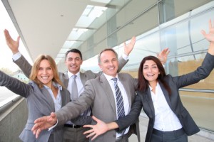 Group of happy business people with arms up